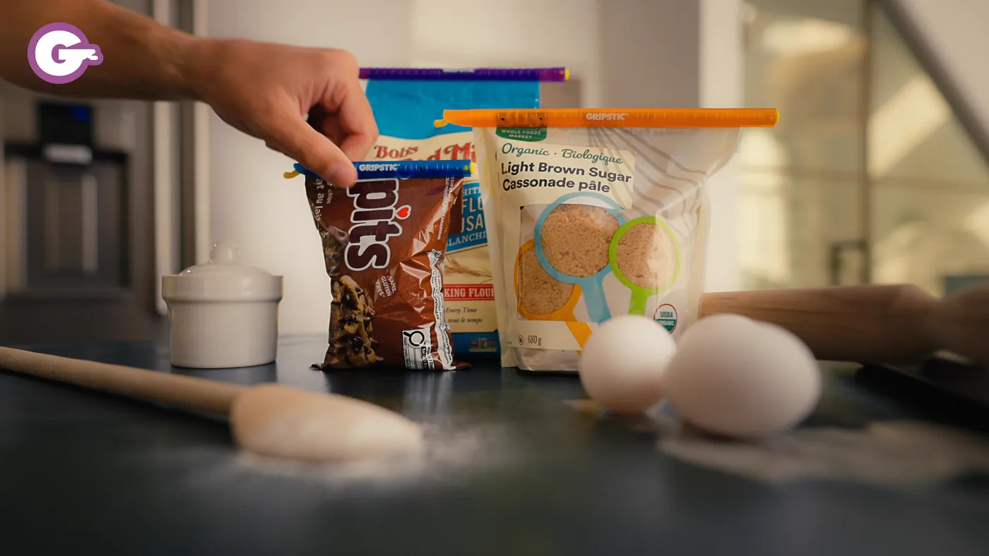Sealed bags of chocolate chips and brown sugar on a kitchen counter