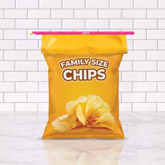 Pink 13-inch GRIPSTIC sealing a family-size bag of chips